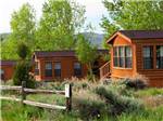 A row of wooden rentals at THOUSAND TRAILS BLUE MESA RECREATIONAL RANCH - thumbnail