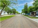 Long road flanked by campsites at K & R RV PARK - thumbnail