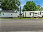 Fifth-wheel on paved site next door to park model at K & R RV PARK - thumbnail