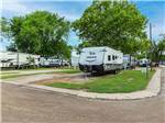 Jayco travel trailer in campsite with concrete patio at K & R RV PARK - thumbnail