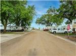 Straight road flanked by paved RV sites at K & R RV PARK - thumbnail