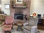 A sitting area by the fireplace at RIVER VIEW RV PARK AND RESORT - thumbnail