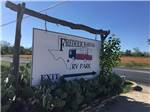 Cactus patch with sign at park exit at FREDERICKSBURG RV PARK - thumbnail