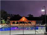 Evening view of pool with pavilion in distance at OCEAN CITY CAMPGROUND AND BEACH CABINS - thumbnail