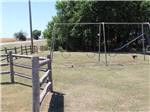 Playground next to a fence at NORTH STAR RV PARK - thumbnail