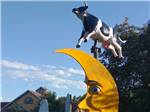 A whimsical sculpture of a cow and moon  at WYLIE PARK CAMPGROUND & STORYBOOK LAND - thumbnail