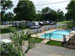 Swimming pool with RVs in background at RIVERSIDE RV PARK - thumbnail