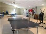 The ping pong table with round tables in the background at CARTHAGE RV CAMPGROUND - thumbnail