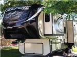 Fifth wheel in campsite at NEW VISION RV PARK - thumbnail