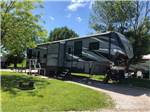 Side view of fifth wheel in campsite at NEW VISION RV PARK - thumbnail