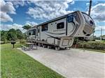 A fifth wheel trailer in a paved back in RV site at OUTBACK RV RESORT AT TANGLEWOOD - thumbnail