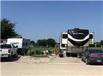 A fifth wheel trailer in a back in RV site at NEW LIFE RV PARK - thumbnail