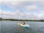 A young couple kayaking in the lake at WILLOWTREE RV RESORT & CAMPGROUND - thumbnail
