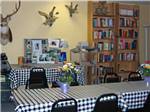 Long tables and a selection of books at ARROWHEAD CAMPGROUND - thumbnail
