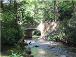 A stone bridge that is running over a river at ECHO VALLEY CAMPGROUND - thumbnail