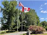 The American and Canadian flags flying at PUMPKIN PATCH RV RESORT - thumbnail