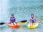 A couple of kids kayaking at EMERALD LAKE TRAILER RESORT & WATERPARK - thumbnail