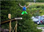 A kid jumping off a dock at EMERALD LAKE TRAILER RESORT & WATERPARK - thumbnail