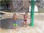 A couple of kids playing in the splash pad at EMERALD LAKE TRAILER RESORT & WATERPARK - thumbnail