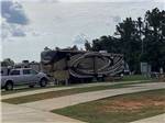 A fifth wheel trailer backed in at RV HIDEAWAY CAMPGROUND - thumbnail