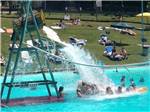 Water splashing on kids in the swimming pool at PINE COVE BEACH CLUB & RV RESORT - thumbnail