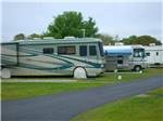 A line of motorhomes in sites at TICE COURTS & RV PARK - thumbnail