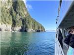Side of boat and view of mountain at STAN STEPHENS GLACIER & WILDLIFE CRUISES - thumbnail