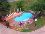Swimming pool with outdoor seating at SHALLOW CREEK RV RESORT - thumbnail