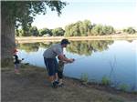 Father showing son how to fish at SAN BERNARDINO COUNTY REGIONAL PARKS - thumbnail