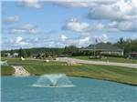 Shot of main building with pond in foreground at TRAVERSE BAY RV RESORT - thumbnail