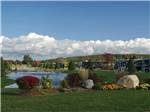 RVs in campsites overlooking pond at TRAVERSE BAY RV RESORT - thumbnail