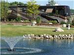 Motorhome in landscaped site near fountain at TRAVERSE BAY RV RESORT - thumbnail