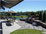 Expansive RV site patio overlooking a pond at TRAVERSE BAY RV RESORT - thumbnail
