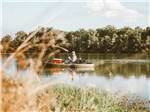 A man in a boat fishing at LAKESIDE RV RESORT BY RJOURNEY - thumbnail