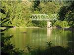 Green metal bridge over river at SANDY RIVERFRONT RV RESORT - thumbnail