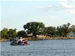 A couple of personal watercrafts on the water at SUNSET POINT ON LAKE LBJ - thumbnail