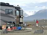 A family and dog walking in front of a motorhome at HERITAGE RV PARK - thumbnail