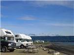 A line of RVs along the water at HERITAGE RV PARK - thumbnail