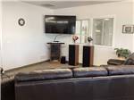 A TV and leather couch at AMBASSADOR RV RESORT - thumbnail