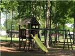 The playground equipment under trees at JOLLY ACRES RV PARK & STORAGE - thumbnail
