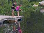 Girls fishing at MEREDITH WOODS 4 SEASON CAMPING AREA - thumbnail