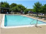 Large swimming pool with lounge chairs at TEXAN RV RANCH - thumbnail