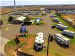 Overhead shot of entrance, office and sites with rigs at MESA VERDE RV PARK - thumbnail