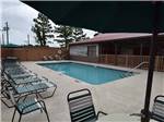 Seating around the swimming pool at WILD FRONTIER RV RESORT - thumbnail