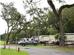 A row of RV sites on a paved road at WILD FRONTIER RV RESORT - thumbnail