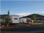 Two fifth wheel trailers parked in a RV site at GRAND CANYON RAILWAY RV PARK - thumbnail