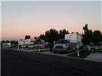 A row of paved RV sites at dusk at MOUNTAIN HOME RV RESORT - thumbnail