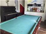 The pool table and piano at POCHE PLANTATION RV RESORT - thumbnail