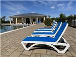 Lounge chairs around the pool at CAMPING LA CLE DES CHAMPS RV RESORT - thumbnail
