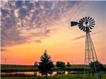 A windmill by the lake at dusk at FISHBERRY CAMPGROUND - thumbnail